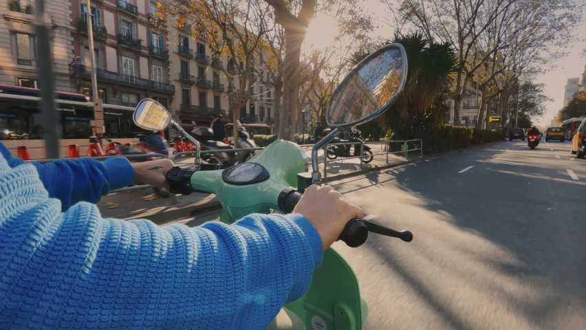 Side shot of man driving cute new electric moped from sharing app. Use green energy for better environmental impact. Awesome summer adventure, driving motorbike on city streets. European holiday Royalty-Free Stock Footage #1064435668