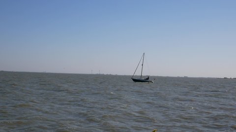 Volendam, the Netherlands - april 22 2020: Sailboat is sailing away in Volendam