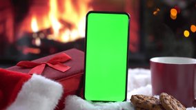 Smartphone with green screen on Christmas background