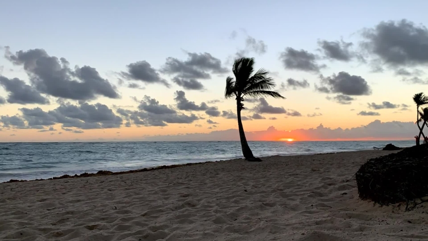 Time lapse: sunrise beach over the sea. Dominican Republic. The bright yellow sun rises over the horizon. Sea and beach natural sunrise.
