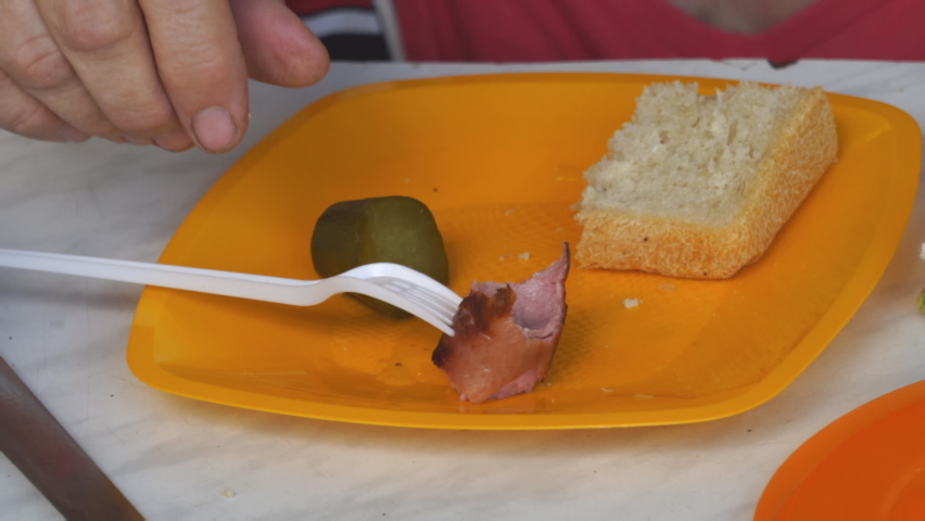 Snack on plastic disposable plate. Disposable tableware