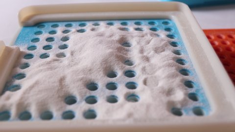 close up white powder for capsule in hole of filling machine for medicine and antivirus or vaccine, prepare medicine concept.