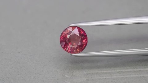 natural round red sapphire on the grey background