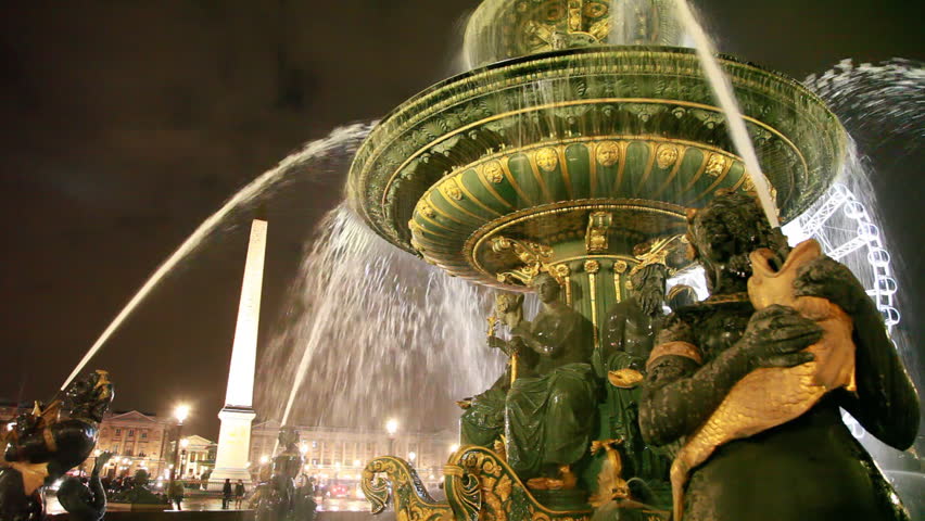 Luxor obelisk and Fontaine des Mers at Place de la Concorde in evening.