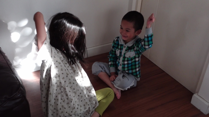 2 Cute Asian sibling playing Rock, paper, scissors,RPS is a game for two people that encourages fast thinking and a lot of laughs.