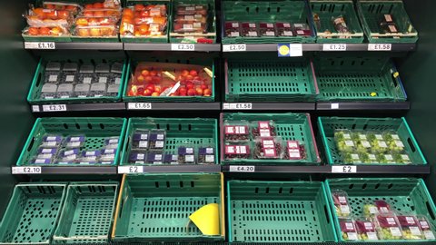 London UK, December 23rd 2020: Tesco fruit and vegetable baskets on shelves. Signs of low supplies to re-stock, during Covid-19, coronavirus pandemic. Concept for food shortage, delays and low stocks.