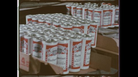 1970s St. Louis, MO. Budweiser Cans roll off the Package Line at the Anheuser-Busch Facotry.  4K Overscan of Archival 16mm Film 