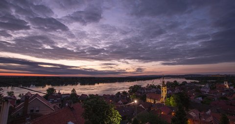 Night to a day time lapse of sunrise over Danube river and Belgrade city viewed from Gardos in Zemun.