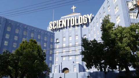 Los Angeles, California USA - 24 Feb 2020: Church of Scientology exterior, facade of blue building near American Saint Hill Organization in Hollywood. Logo and cross. International religious movement.