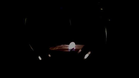 small candle is burning in a candlestick on a black background