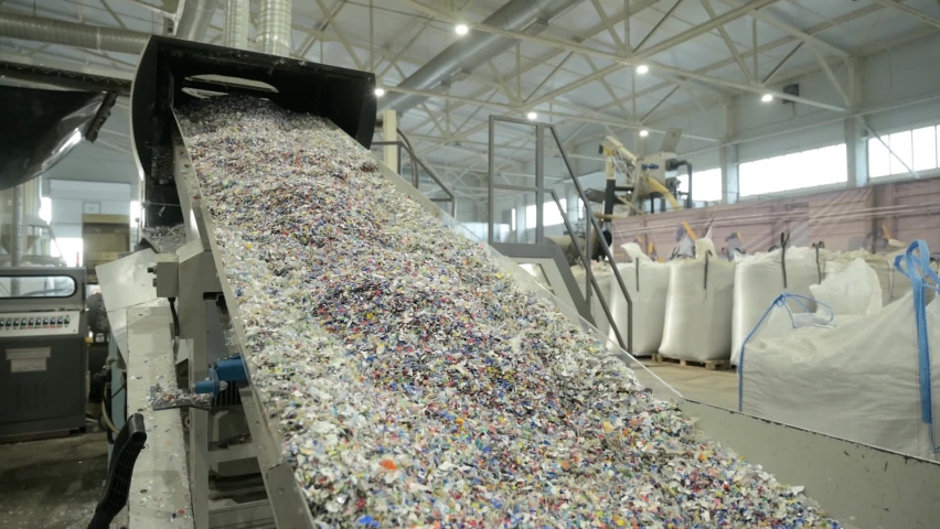 Plastic recycling plant. Conveyor with shredded plastic from PET bottles. | Shutterstock HD Video #1064505466