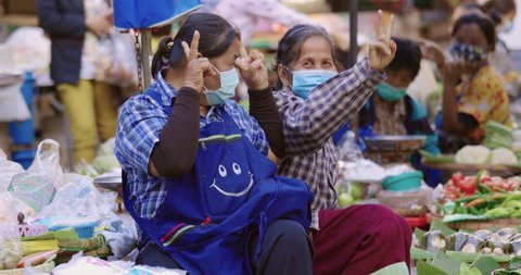 Bangkok - Thailand. December 24, 2020: Sellers Wearing Protective Face Mask Selling Goods To Customer In A Local Street Market. New Normal Lifestyle During Corona Virus, COVID 19 Epidemic Or Pandemic.
