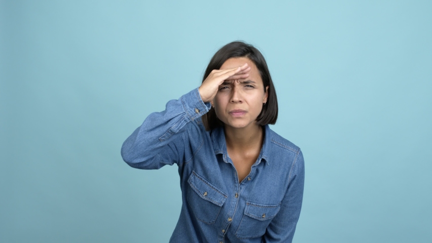 Young latin woman looking far away with hand to look something over isolated background