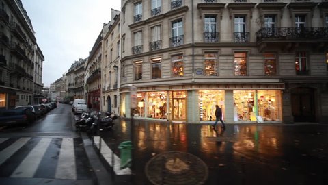streets and homes with showcases in heart of Paris, view from passing bus window