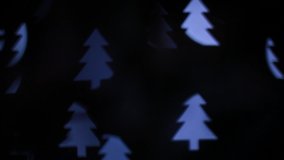 Christmas lights in the form of a Christmas tree. Blurred background. Flashing abstract colored spruce blurred. Christmas lights video. Blurred fairy lights