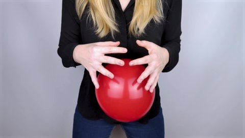 Bloating and flatulence. The woman holds a red ball near her belly, symbolizing bloating, then lets go, symbolizing relief from the problem. Problems with flatulence and gastrointestinal tract