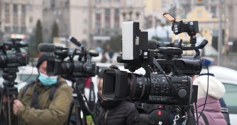 KYIV, UKRAINE, DECEMBER 22, 2020: Video operators with camcorders on tripods at protest rally of private entrepreneurs on Maidan Nezalezhnosti, Kyiv, Ukraine. Cinema 4K 60fps video