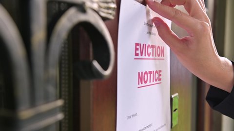 Close-up of a tenant's eviction notice gluing to the door