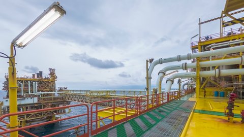 4K time lapse at process area of  yellow centre processing platform of oil and gas in the middle of South China sea with cloudy weather.