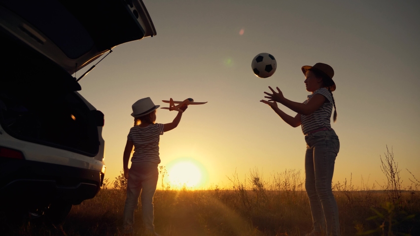 Happy children sunset play ball, airplane.Happy family spend fun summer vacation together in nature. kid plays as an airplane pilot.Children funny active games in park.kid family with a ball sunset. | Shutterstock HD Video #1064533423