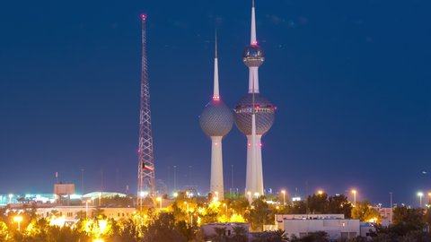 Top view of Kuwait Towers day to night transition timelapse illuminated at night - the best known landmark of Kuwait City. Kuwait, Middle East.