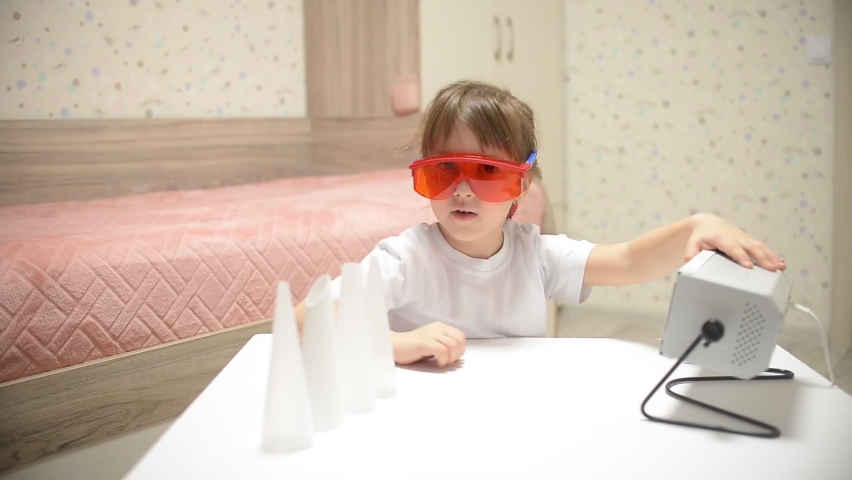 the child is preparing for the prevention of diseases with Ultraviolet lamp viruses in the children