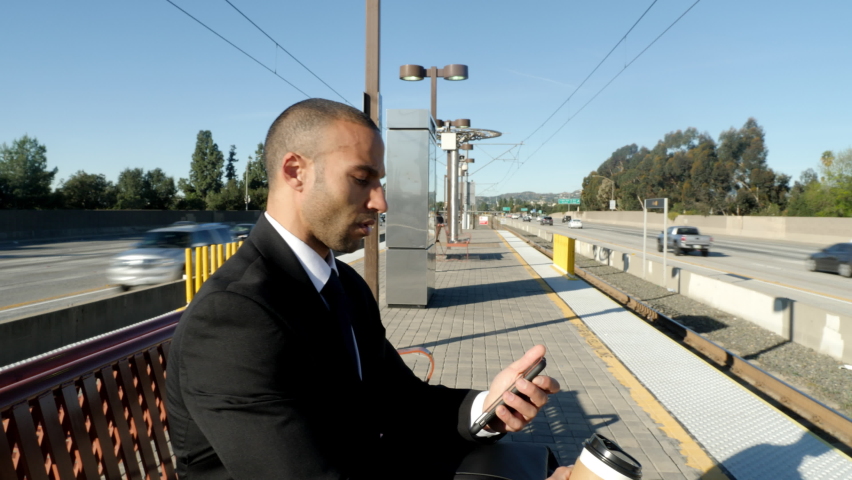 Businessman in a suit waits for a train in Los Angeles