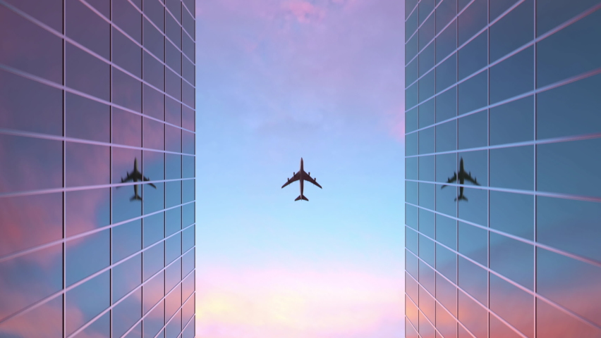 A commercial airplane flies over two glass skyscrapers with reflective windows as seen from below | Shutterstock HD Video #1064557081