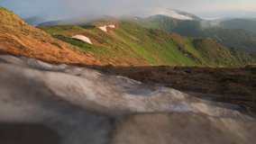 Amazing morning summer mountains. Snow and moving clouds on mountains hills on background. UHD 4K video