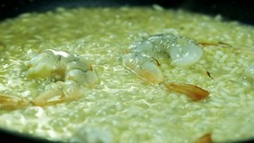 Chef Adds Spices to Risotto. Close-Up Food. Cooking Process. Chef Cooking Dish. Chef Preparing Food. (Red Dragon, Cinematic Quality Macro Footage).
