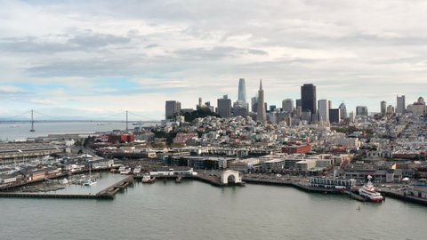 San Francisco, USA. Aerial footage of modern architecture in the downtown. Skyscrapers and docks with Bay bridge in the background. High quality 4k footage