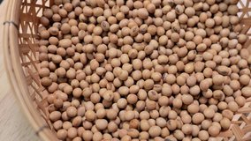 Raw soybean seed food organic top view texture, High in fiber, helps prevent cancer, supplementary food, Protein healthy food, video footage, Close-Up Shot of Soybean Falling, slow motion.