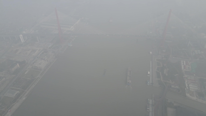 City in heavy haze and air pollution. Building and roads in fog in day time. Environmental conservation and air pollution issues concept b-roll footage. Highly polluted residential area Shanghai China