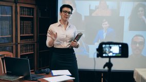 Female professor giving a lecture remotely using a laptop