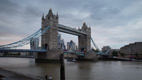 Motion time lapse of clouds passing over the London skyline and Thames river including Tower Bridge.  Camera moves forward as day changes to night