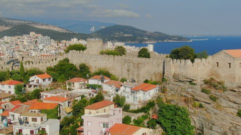 Aerial drone view above Greek town Kavala. Flying top view of old town and sea port of famous UNESCO world heritage historic monument from medieval roman empire ages.