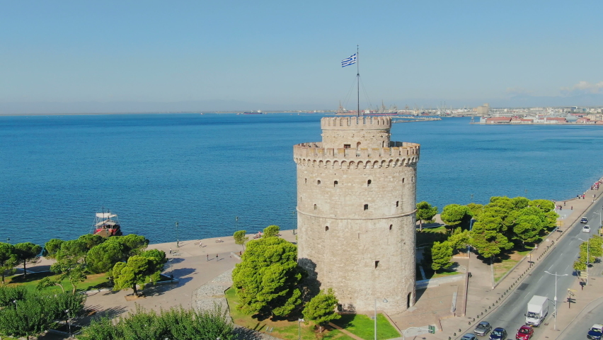 Aerial shot view, flying above Greek town Thessaloniki. Aerial view famous UNESCO world heritage White tower, historic monument from medieval roman empire ages.