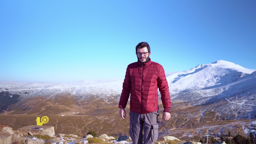 Man reaching snowy mount top success in sunny day. Dolly shots