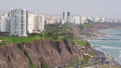 Aerial view of the green coast highway and buildings of  Miraflores district with view of the pacific ocean, in Lima, Peru