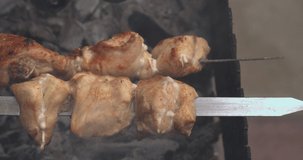 Chicken and vegetables preparation on vacation, bbq party outdoor. Cooking turkish kebab on flame with smoke, camping. Slow motion of preparing barbecue chicken