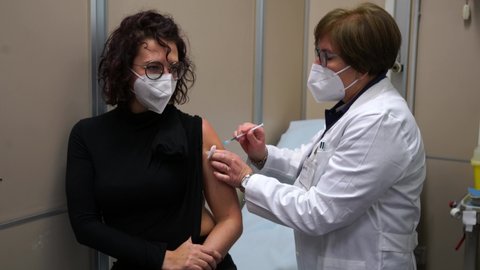 Start Of Vaccination Against Covid-19, a woman receives the Pfizer's coronavirus vaccine, at the Amedeo di Savoia Hospital. Turin, Italy - December 27, 2020