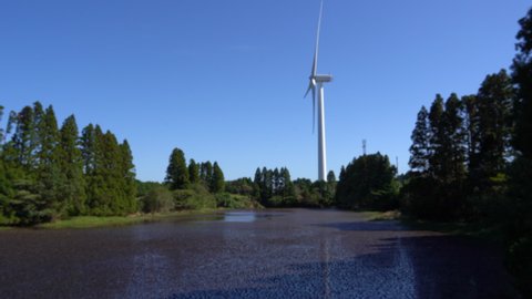 wind power generators are standing behind a pond in Saga prefecture, JAPAN. Without sounds