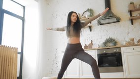 Young Woman doing balance exercise and Stretching sports Yoga, brown Sportswear Leggings and Top, bright room At home with Christmas decor.