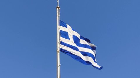 Close Up View of a Greek Flag Waving Proudly in Slow Motion Under the Bright Blue Sky on Parthenon Temple in Athens City, Greece, 4K Video Footage