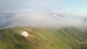 Magic sunrise in foggy summer Carpathian mountains from fliying drone. Misty mountain valley and hight peaks on background. UHD 4k video