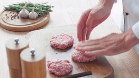 Cropped view of chef forming mince patty on chopping board near ingredients