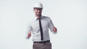 happy architect in hardhat and glasses dancing isolated on white