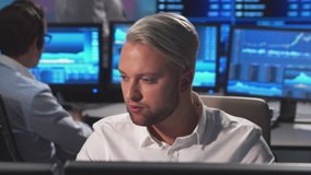 Diverse team of brokers workin in office using workstation and analysis technology. Workplace of professional traders. Global financial markets, business, currency exchange and banking concepts. - Powered by Shutterstock - Get 15% off with code: PIKWIZARD15