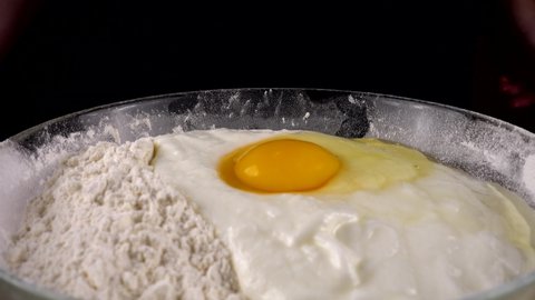 Preparing the dough in a bowl with flour, egg and yogurt.