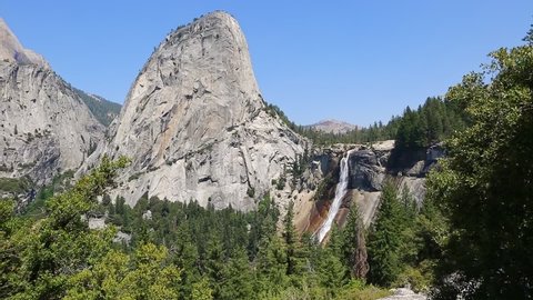 Panorama of Liberty Cap and Nevada Fall waterfall on Merced River from John Muir trail in Yosemite National Park. Summer travel holidays in California, United States.